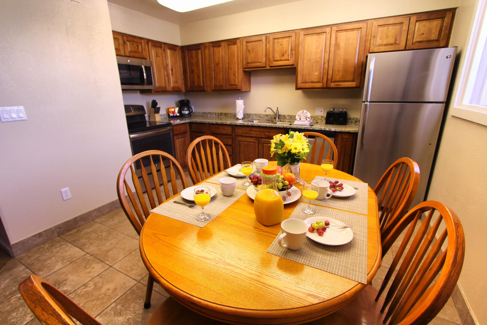 A fully equipped kitchen and dining table at VRI's Villas at South Gate in St George, Utah.